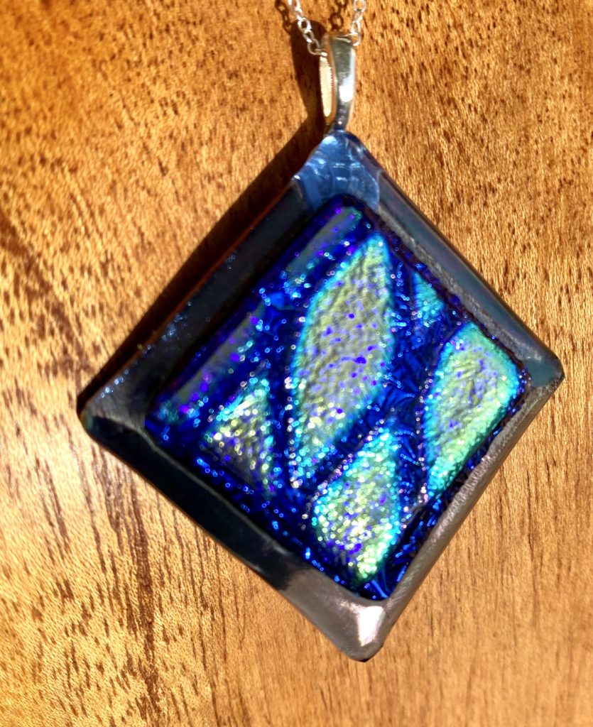 Patterned dichroic glass layered on iridescent dichroic glass - Onlyology